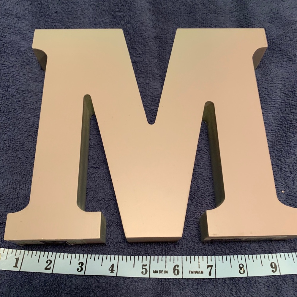 Decorative initial “M”.